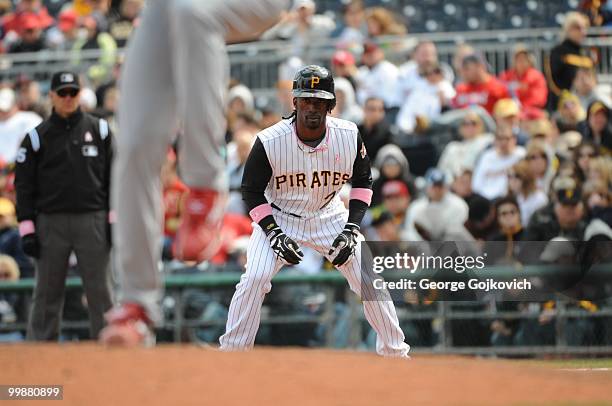 Outfielder Andrew McCutchen of the Pittsburgh Pirates watches the pitcher as he leads off first base during a game against the St. Louis Cardinals at...