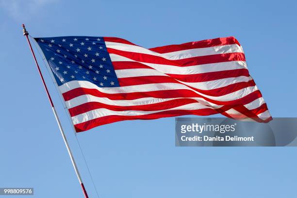 american flag waving above liberty station, san diego, california, usa - diego rojas fotografías e imágenes de stock