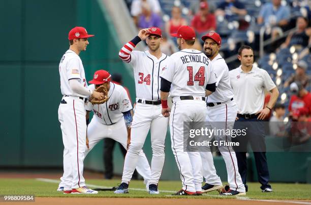 Trea Turner, Juan Soto, Bryce Harper, Mark Reynolds and Anthony Rendon of the Washington Nationals talk before the game against the Boston Red Sox at...