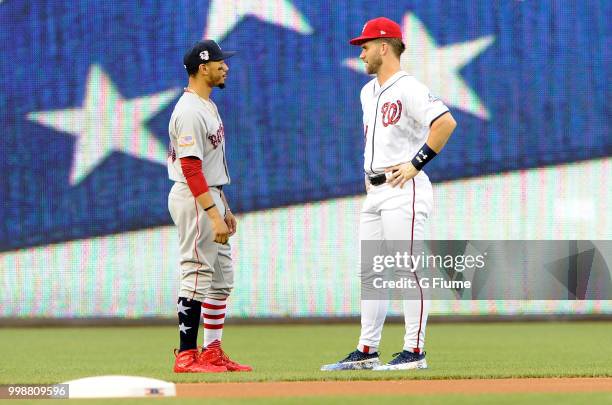 Mookie Betts of the Boston Red Sox and Bryce Harper of the Washington Nationals talk before the game at Nationals Park on July 3, 2018 in Washington,...