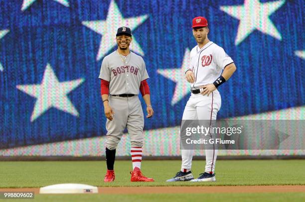 Mookie Betts of the Boston Red Sox and Bryce Harper of the Washington Nationals talk before the game at Nationals Park on July 3, 2018 in Washington,...