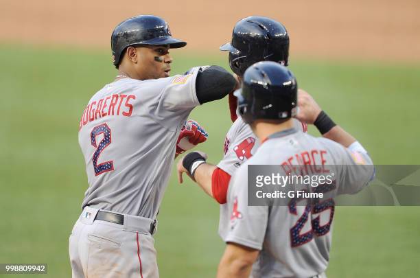 Xander Bogaerts of the Boston Red Sox celebrates with J.D. Martinez and Steve Pearce after hitting a three-run home run in the fifth inning against...