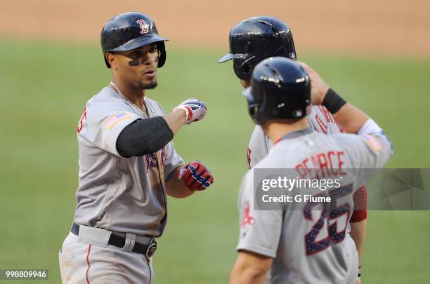 Xander Bogaerts of the Boston Red Sox celebrates with J.D. Martinez and Steve Pearce after hitting a three-run home run in the fifth inning against...