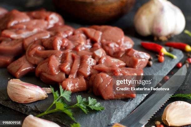 raw beef liver with spices, herbs  and vegetables - unprocessed stock-fotos und bilder