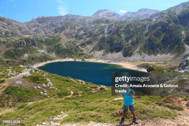 young hiker on calabazosa lake. somiedo natural park, asturias, spain. - ecological reserve stock pictures, royalty-free photos & images