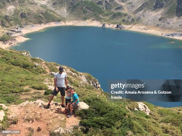 father and children on calabazosa lake. somiedo natural park, asturias, spain. - amaia - fotografias e filmes do acervo