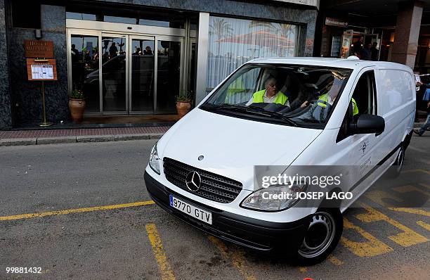 Members of the emergency services remove the bodies of two British children from a hotel in Lloret de Mar on May 18, 2010. Spanish police today...