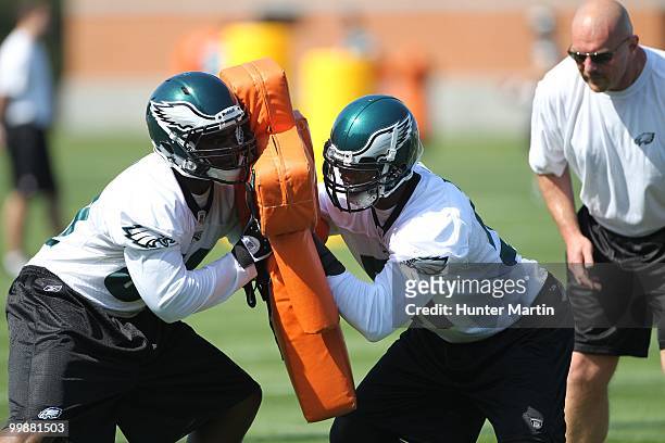 Defensive end Eric Moncur and linebacker Alex Hall of the Philadelphia Eagles participate in drills during mini-camp practice on April 30, 2010 at...