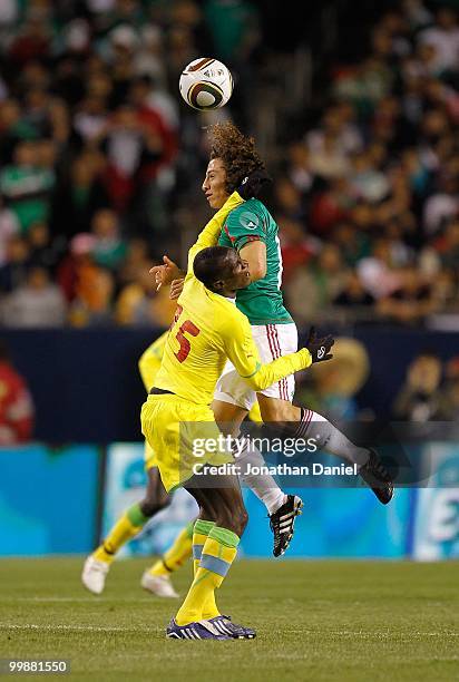 Andres Guardado of Mexico heads the ball over Mame Saher of Senegal during an international friendly at Soldier Field on May 10, 2010 in Chicago,...