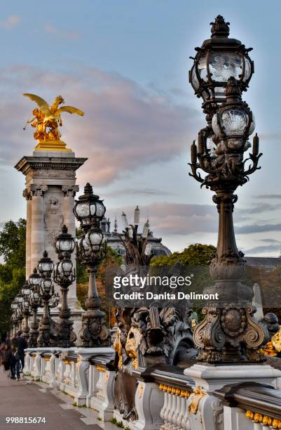 sculptures and lanterns on pont alexandre iii bridge, paris, ile-de-france, france - pont architecture stock-fotos und bilder