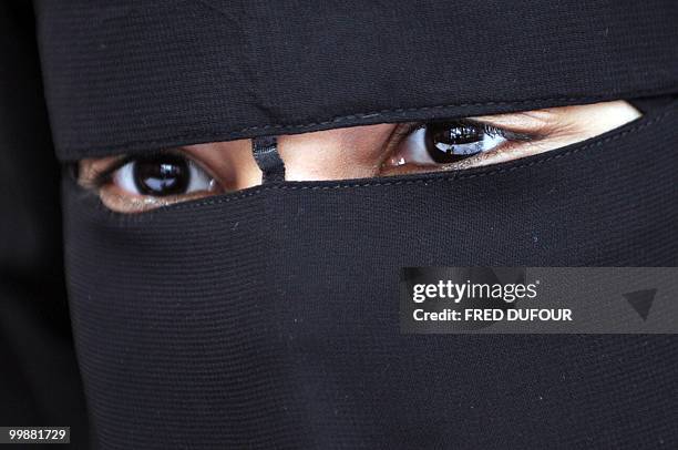 Muslim woman wearing the niqab is pictured during a meeting with Imam Ali El Moujahed on May 18, 2010 in Montreuil, outside Paris. The French...