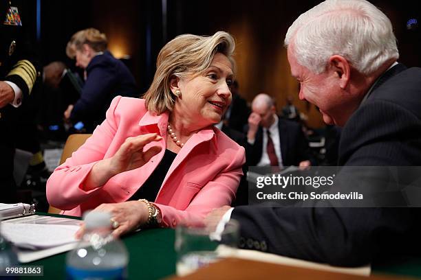 Secretary of State Hillary Clinton talks with Defense Secretary Robert Gates after testifying before the Senate Foreign Relations Committee about the...