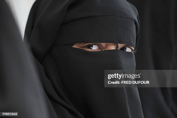 Muslim woman wearing the niqab poses during a meeting with Imam Ali El Moujahed on May 18, 2010 in Montreuil, outside Paris. The French parliament...