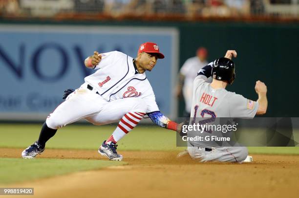 Brock Holt of the Boston Red Sox is tagged out by Wilmer Difo of the Washington Nationals while trying to steal second base in the eighth inning at...