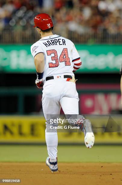Bryce Harper of the Washington Nationals rounds the bases after hitting a home run in the eighth inning against the Boston Red Sox at Nationals Park...