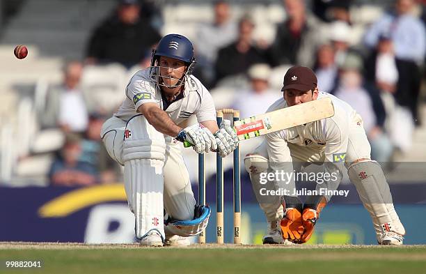 Andrew Strauss of Middlesex in action as wicket keeper, Gary Wilson of Surrey watches on during day two of the LV= County Championship match between...