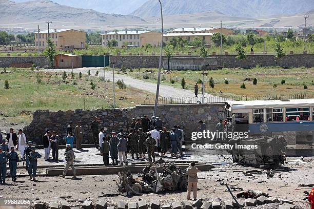 Afghan and foreign investigators inspect the site of a suicide car bomb attack on May 18, 2010 in Kabul, Afghanistan. The Taliban attack targeting a...