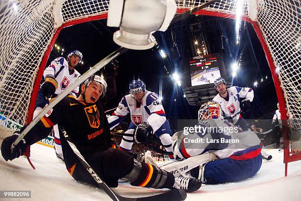 Christoph Ullmann of Germany scores an irregular goal with his foot past goaltender Peter Budaj of Slovakia during the IIHF World Championship...