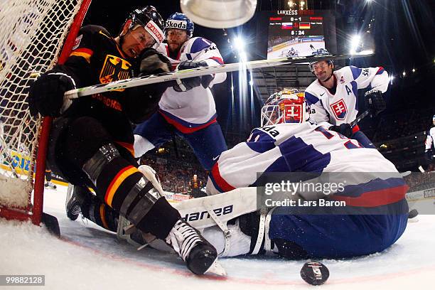 Christoph Ullmann of Germany scores an irregular goal with his foot past goaltender Peter Budaj of Slovakia during the IIHF World Championship...