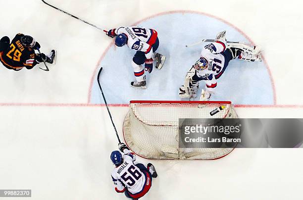 Alexander Barta of Germany scores the first goal past goaltender Peter Budaj of Slovakia during the IIHF World Championship qualification round match...