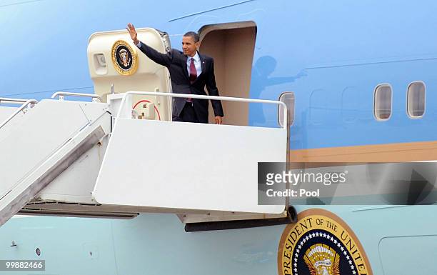 President Barack Obama waves as he boards Air Force One at Joint Base Andrews Naval Air Facility May 18, 2010 in Camp Springs, Maryland. Obama is on...
