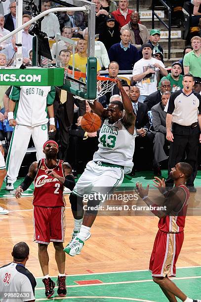 Kendrick Perkins of the Boston Celtics slam dunks over Mo Williams and Antawn Jamison of the Cleveland Cavaliers in Game Six of the Eastern...