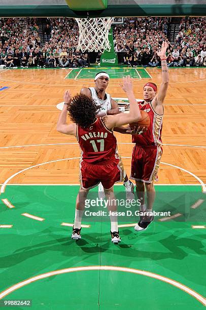 Rajon Rondo of the Boston Celtics goes to the basket against Anderson Varejao and Delonte West of the Cleveland Cavaliers in Game Six of the Eastern...