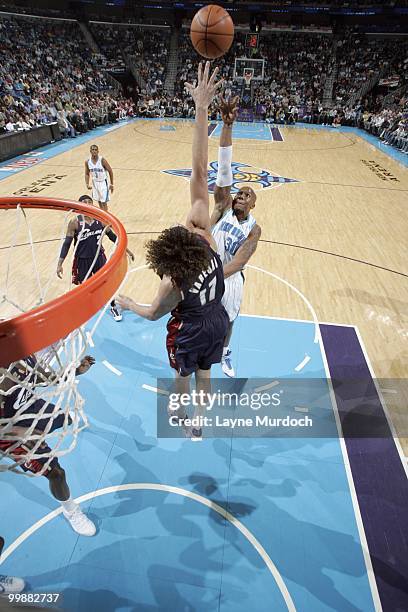 David West of the New Orleans Hornets puts a shot up against Anderson Varejao of the Cleveland Cavaliers on March 24, 2010 at the New Orleans Arena...