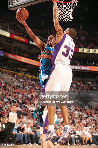 Marcus Thornton of the New Orleans Hornets puts a shot up against Grant Hill of the Phoenix Suns during an NBA Game on March 14, 2010 at U.S. Airways...
