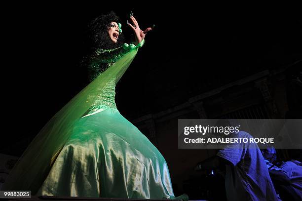 Cuban transvestite gestures as he walks down the catwalk during a transvestite show, on May 17 in Santa Clara city - 300 km from Havana. This...