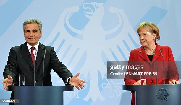 German Chancellor Angela Merkel and the Austrian Chancellor Werner Faymann give a joint press conference on May 18 following bilateral talks at the...