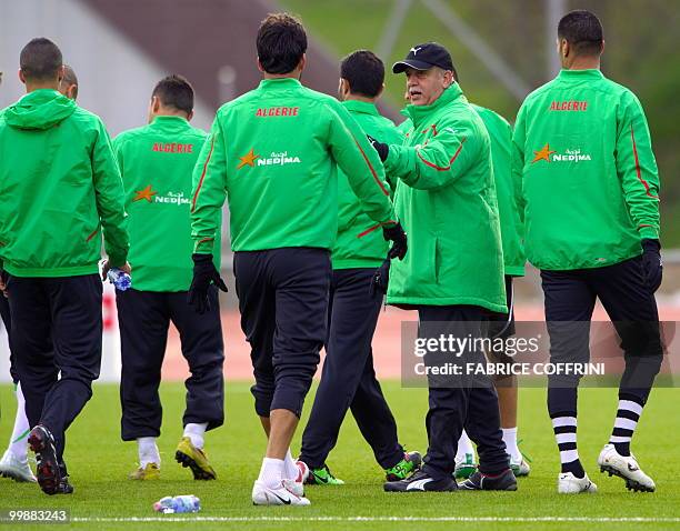 Algerian national football team coach Rabah Saadane stands among his players during a practice session on May 18, 2010 in the Swiss Alpine resort of...