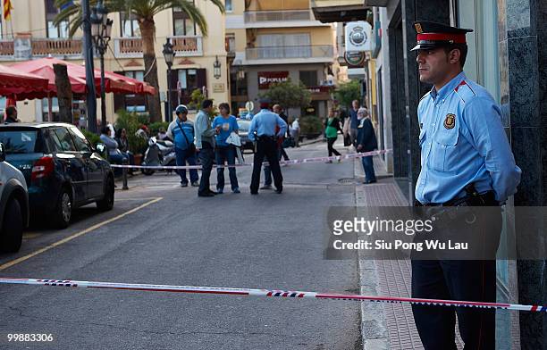 Police stand guard outside the Hotel Miramar where two children, believed to be British, have been found dead in a hotel room on May 18, 2010 in the...