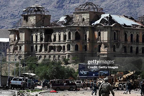 Afghan and foreign investigators inspect the site of a suicide car bomb attack on May 18, 2010 in Kabul, Afghanistan. The Taliban attack targeting a...