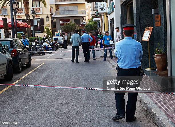 Police stand guard outside the Hotel Miramar where two children, believed to be British, have been found dead in a hotel room on May 18, 2010 in the...