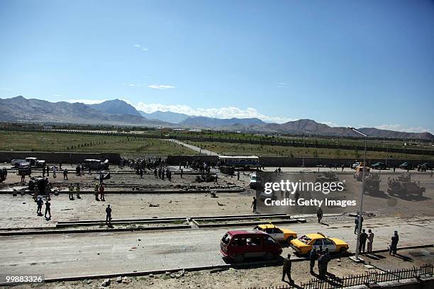 Afghan and foreign investigators inspect the site of a suicide car bomb attack on May 18, 2010 in Kabul, Afghanistan. The Taliban attack targeting a...