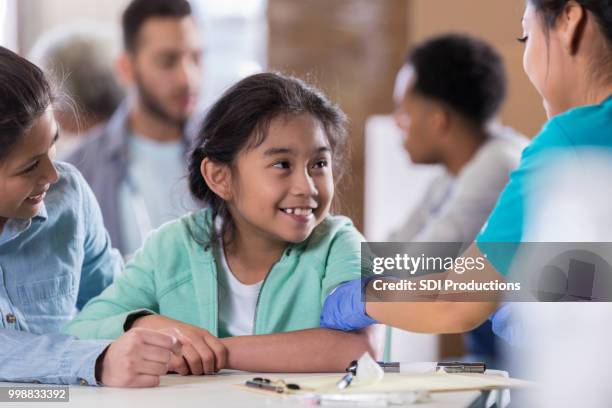 little girl receives flu vaccine - family health club stock pictures, royalty-free photos & images