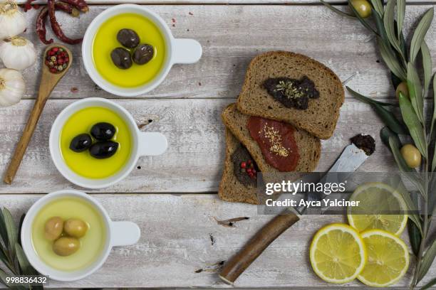 bread slices and olive oil on wood - oil on wood stock pictures, royalty-free photos & images