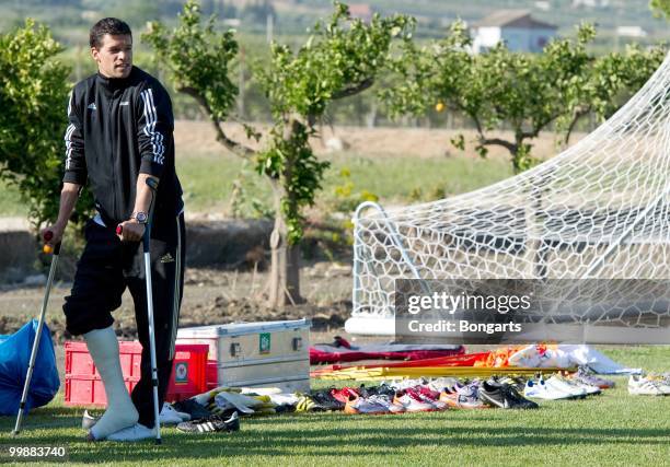 Injured Michael Ballack watches his team during the German National Team training session at Verdura Golf & Spa Resort on May 18, 2010 in Sciacca,...