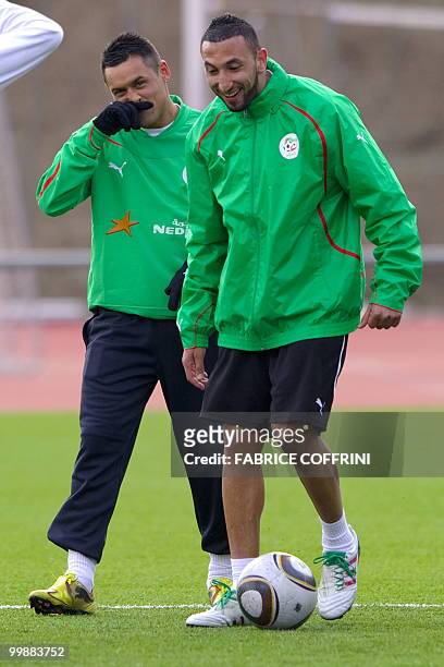 Algeria team's Karim Ziani gestures beside teammate Nadir Belhadj during a practice session on May 18, 2010 in the Swiss Alpine resort of...