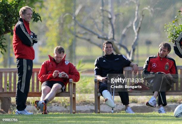 Injured Michael Ballack watches his team during the German National Team training session at Verdura Golf & Spa Resort on May 18, 2010 in Sciacca,...