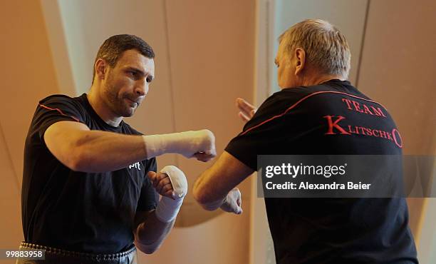 Ukrainian boxer Vitali Klitschko warms up with his coach Fritz Sdunek during a training session on May 18, 2010 in Going, Austria. The WBC...