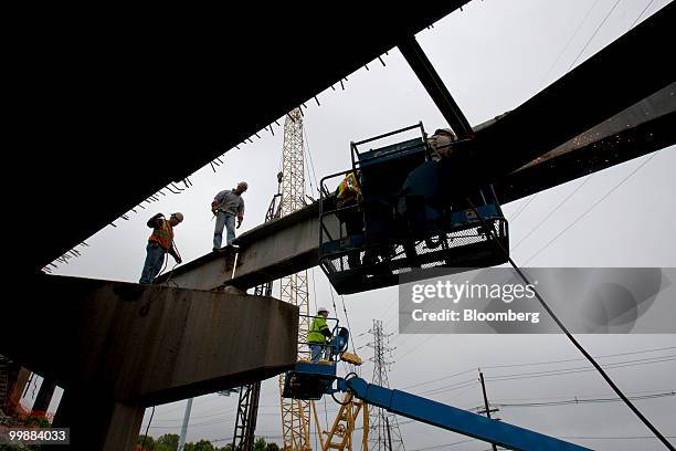 Workers extend an overpass on the New Jersey Turnpike in Bordentown, New Jersey, U.S., on Wednesday, May 12, 2010. New Jersey, the third-most...