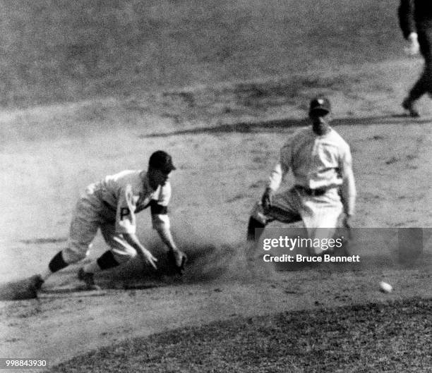 Roger Peckinpaugh of the Washington Senators steals second base as Eddie Moore of the Pittsburgh Pirates waits for the ball during Game 4 of the 1925...