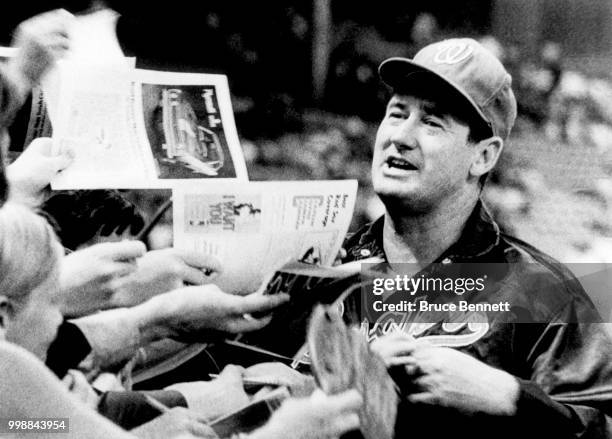 Manager Ted Williams of the Washington Senators signs autographs prior to an MLB game against the Boston Red Sox on September 5, 1969 at Fenway Park...