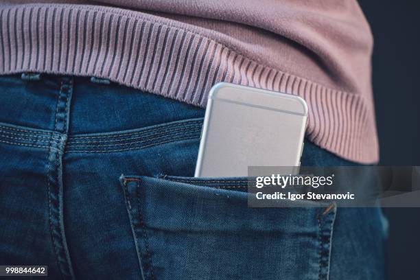 woman with smartphone in blue jeans back pocket - phone in back pocket stock pictures, royalty-free photos & images