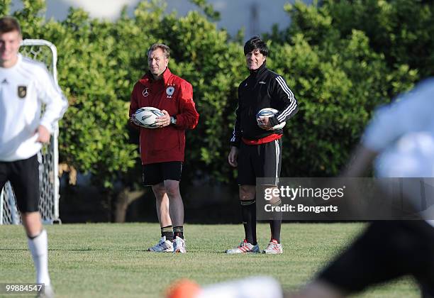 Head coach Joachim Loew of Germany and goalkeeping coach Andreas Koepke watch the players exercising during a German National Team rugby training...