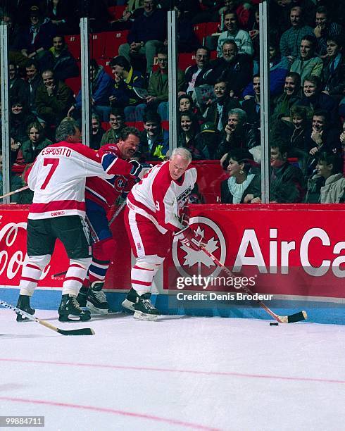 Gordie Howe and Phil Esposito of the Heroes of Hockey skate against Pierre Bouchard of the Montreal Canadiens during NHL All-Star Weekend in...