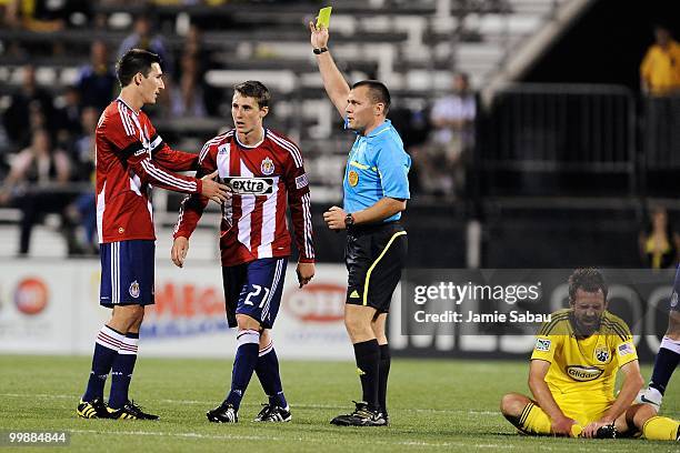 Referee Jeff Gontarek issues a yellow card to Ben Zemanski of Chivas USA in a game against the Columbus Crew on May 15, 2010 at Crew Stadium in...