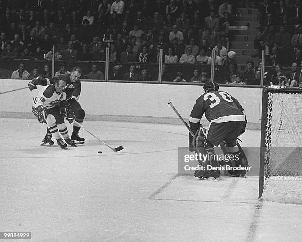 Roger Crozier protects the net while Gordie Howe of the Detroit Red Wings skates against Henri Richard of the Montreal Canadiens in 1965 at the...